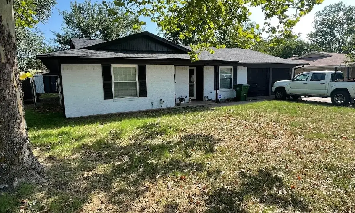 Professional roofing crew working on a residential roof in McNair